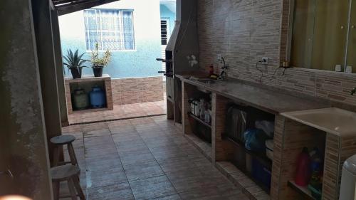 a kitchen with a sink and a counter top at Villa Caiçara in Ubatuba