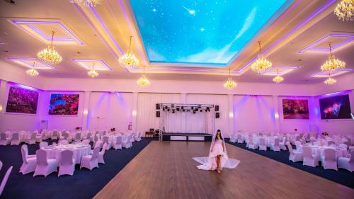 a wedding hall with white tables and white chairs at Conacul Domnesc in Suceava