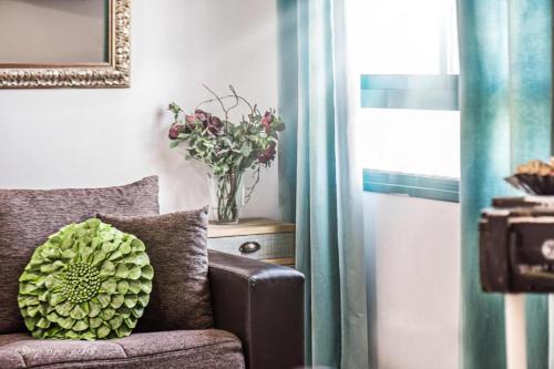 a vase of flowers sitting on top of a couch at Luxury Apartment on the Lake in Tiberias