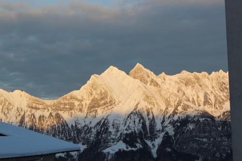a view of a snow covered mountain range at Chalet Good in Flumserberg
