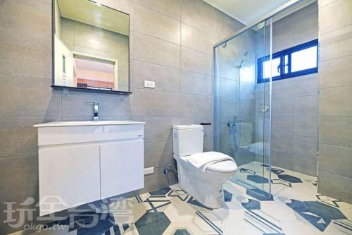 a bathroom with a toilet and a sink and a shower at S-Home in Huxi