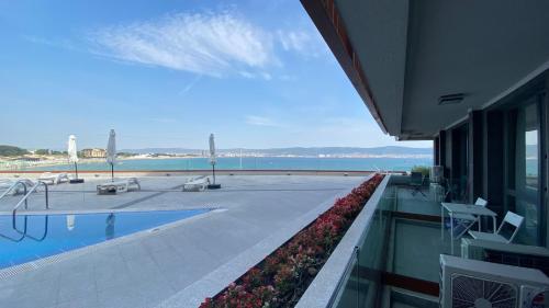 a view of a swimming pool and the ocean from a building at PARADISO 'В' 107 Private Cozy Studio NESSEBAR in Nesebar