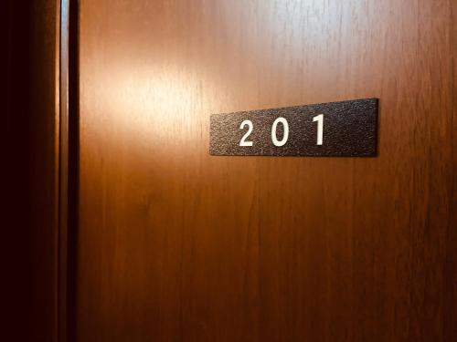 a door with a sign that says on it at Pension Razteca in Hakuba