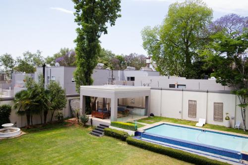 an exterior view of a house with a swimming pool at The Houghton Villa in Johannesburg
