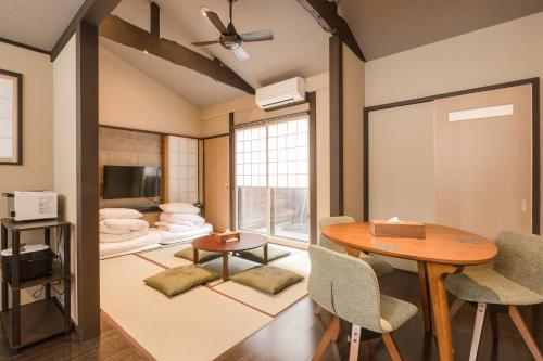 a living room with a table and chairs and a couch at Shiki Homes SEN in Kyoto