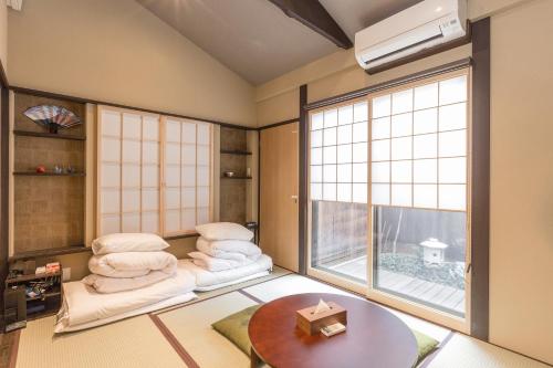 a room with two chairs and a table and a window at Shiki Homes SEN in Kyoto