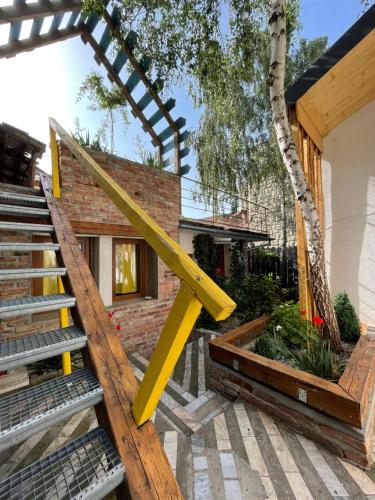 a house renovation with a yellow stair railing at Apartament Art Cluj in Cluj-Napoca