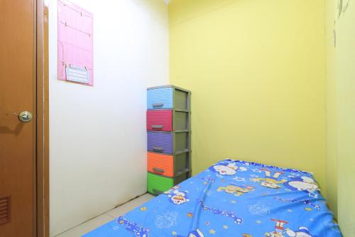 a small bedroom with a bed and a closet at Eiffel Residence Batu Tulis 35A1 - Female Only in Jakarta