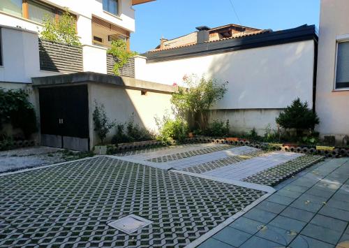 an empty courtyard with a grate in front of a building at Tuzlaks appartment in Sarajevo