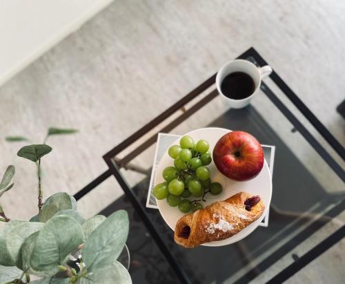 a plate of fruit on a table with a cup of coffee at Motobu Terrace in Motobu