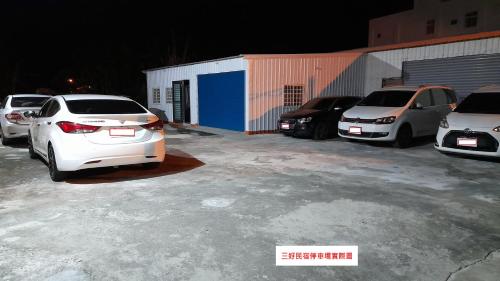a group of cars parked in a parking lot at Sun Good Hostel in Hengchun