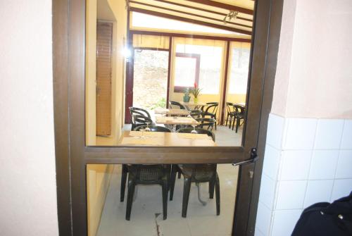 a view of a dining room with a table and chairs at Le Logis Charmant in Charmes-sur-Rhône