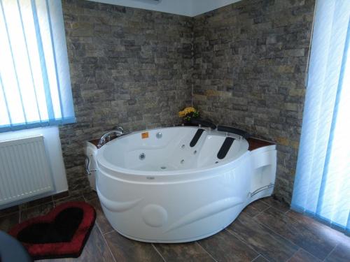 a bathroom with a large white tub in a room at MOTEL ALADIN in Cazin