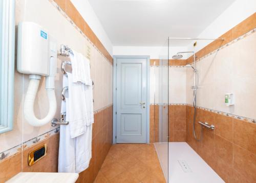 a bathroom with a shower and a glass door at Hotel Du Lac Menaggio in Menaggio
