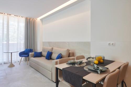 a living room with a couch and a table at Halley Hotel & Apartments Affiliated by Meliá in Benidorm