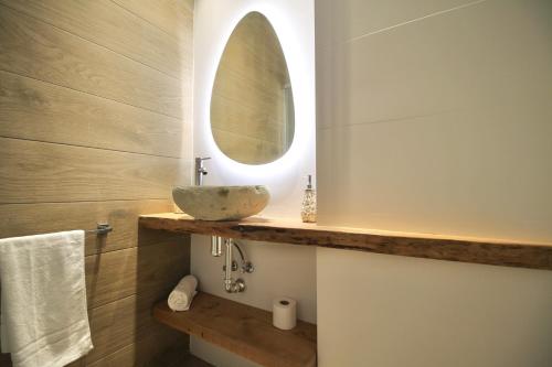 a bathroom with a sink and a mirror at A Loft You Will Fall In Love With in Tarragona