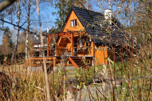 an orange house with a black roof at Chatička na Cikánce in Svratka