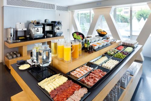 a buffet with many different types of food on display at Hotel Royal Passeig de Gracia in Barcelona