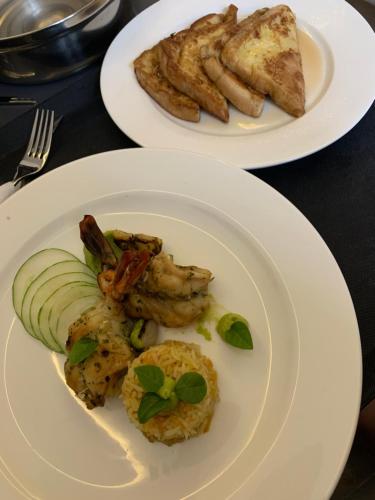 two white plates of food on a table at Gordonsville Escape Boutique Hotel in Port Harcourt