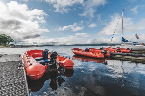 a group of boats are docked at a dock at Hotel Resort Relax in Dolní Vltavice