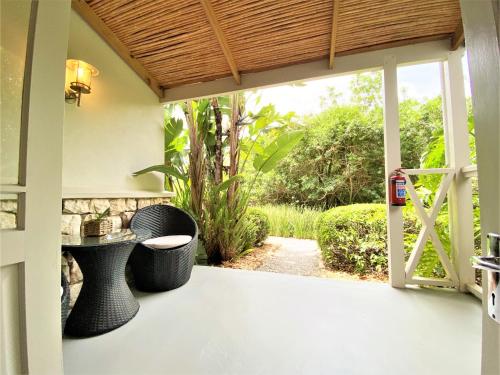 an open door to a patio with a table and chairs at Swellendam Country Lodge - Guest House - B&B in Swellendam