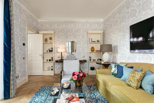 a living room with a couch and a table at Rocco Forte Hotel De Russie in Rome