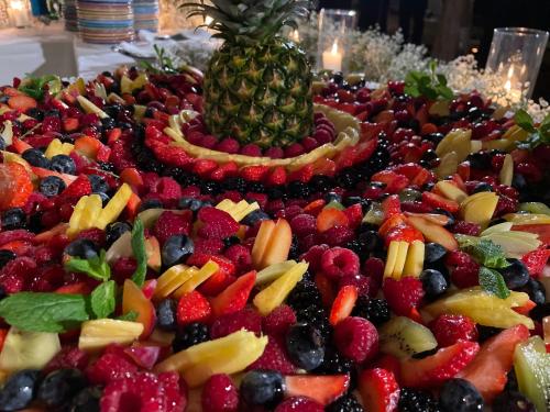 a pile of fruit on a table with a pineapple at Gallia Palace Hotel - Relais & Châteaux in Punta Ala