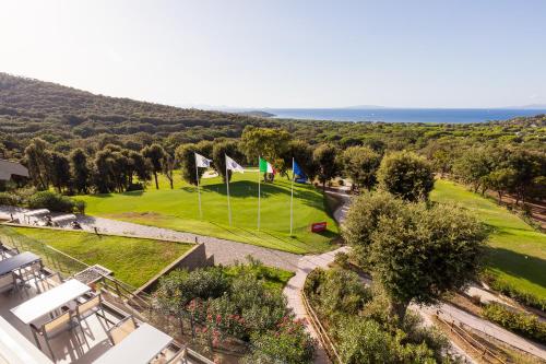 an aerial view of a golf course with flags at Gallia Palace Hotel - Relais & Châteaux in Punta Ala