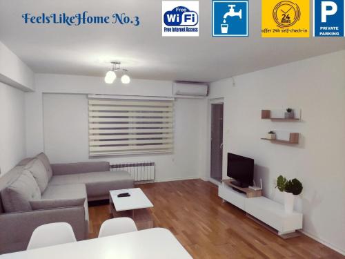 a living room with a couch and a tv at Feels like home 3 in Skopje