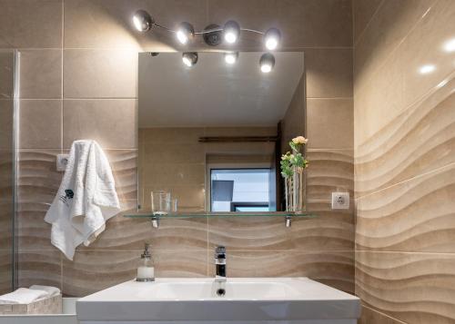 a bathroom with a sink and a mirror at Central Park Home Spa in Arandjelovac