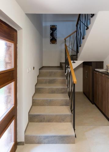a stairway in a home with a wooden door at Central Park Home Spa in Arandjelovac