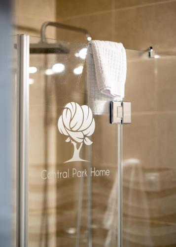a bathroom with a shower with a logo on it at Central Park Home Spa in Arandjelovac