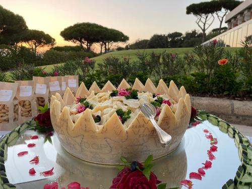 a cake sitting on top of a table with a fork at Gallia Palace Hotel - Relais & Châteaux in Punta Ala