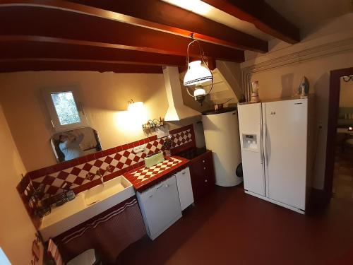 an overhead view of a kitchen with a white refrigerator at Domaine de l’Escuderia in Parentis-en-Born
