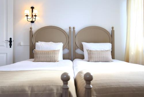 En eller flere senge i et værelse på Solar Do Conde