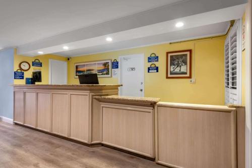 a waiting area in a dental office with yellow walls at Days Inn by Wyndham Maui Oceanfront in Wailea