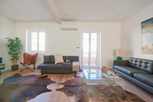 a living room with a couch and a table at Deluxe Apt at Amazing Prime Location, By TimeCooler in Lisbon
