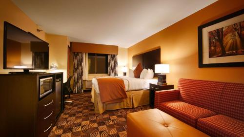 a hotel room with a bed and a couch at Best Western Plus Whitewater Inn in Harrison