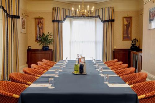a long table in a room with chairs at B/W Plus Buxton Lee Wood Hotel in Buxton