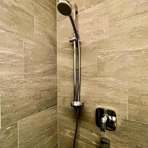 a shower with a shower head in a bathroom at EMMA's Studio in Gerlos
