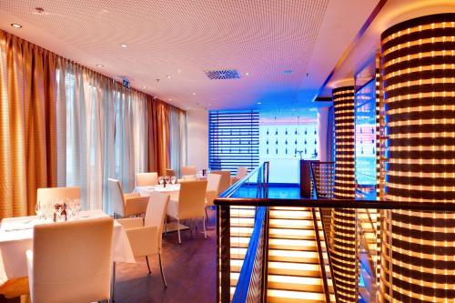 a restaurant with tables and chairs and a view of a city at Radisson Blu Resort Bukovel in Bukovel