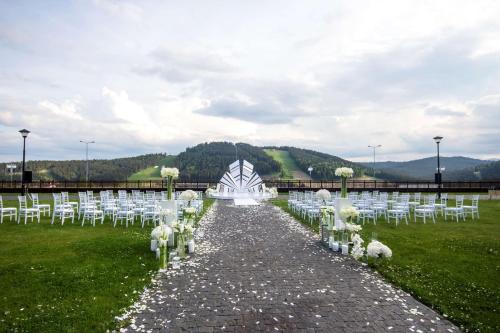 a row of white chairs in a field at Radisson Blu Resort Bukovel in Bukovel