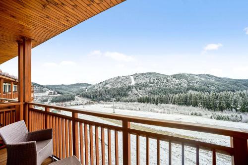 a balcony with a view of a snow covered mountain at Radisson Blu Resort Bukovel in Bukovel