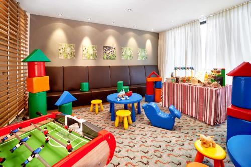 a childrens play room with a table and play equipment at Radisson Blu Resort Bukovel in Bukovel