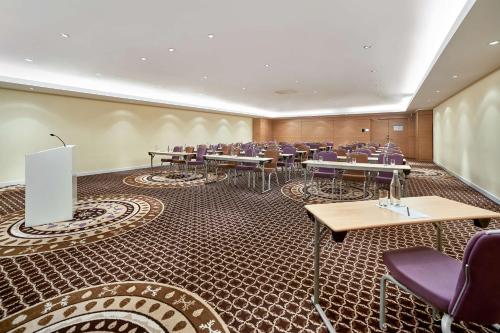 a conference room with tables and chairs in it at Radisson Blu Resort Bukovel in Bukovel