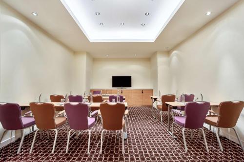 a conference room with tables and purple chairs at Radisson Blu Resort Bukovel in Bukovel