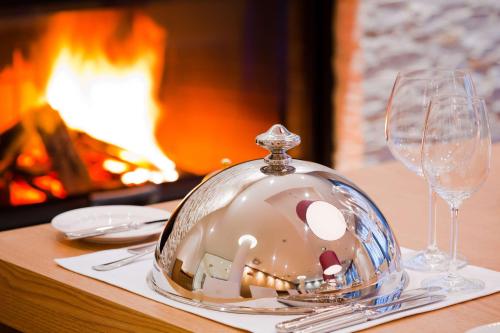 a table with a glass plate on a table with wine glasses at Radisson Blu Resort Bukovel in Bukovel