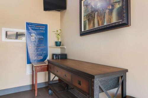 a table in a room with a picture on the wall at Rodeway Inn in Nashville