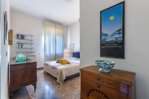 a bedroom with a bed and a dresser at Saffi Huge Apartment a pochi passi dall'Ospedale in Bologna
