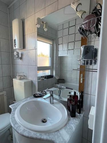 a white bathroom with a sink and a toilet at Wohnen beim Brotsommelier - Frankenlaib in Darmstadt